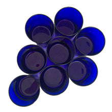 Load image into Gallery viewer, Set of eight vintage cobalt blue Premiere rocks glasses. Crafted by Libbey Glass, USA, circa 1990s. A striking addition to your everyday drinkware or barware collection.

In excellent condition, free from chips. Marked the Libbey L on the bottom.

Measures 3 x 3 3/8 inches

Capacity 10 ounces
