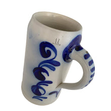 Load image into Gallery viewer, Three-quarter view of a vintage 1L German salt-glazed stoneware beer stein showing cobalt blue scrolled floral design on front, striped handle, and embossed '1l' capacity mark near the rim

