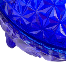 Load image into Gallery viewer, Large vintage cobalt blue love birds 3-footed, lidded candy dish, Byrdes reproduction. A licensed reproduction of the Hofbauer Byrdes model, 1990s. A gorgeous vessel to stash candy, keys, cotton balls and more!!!

In vintage condition with minor smooth chip to the outer rim and minor flea bites to both pieces which do not detract from the beauty of this piece thanks to the deep colour of the glass which tends to hide small issues.

Measures 7 1/2 x 7 1/2 inches
