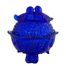 Load image into Gallery viewer, Large vintage cobalt blue love birds 3-footed, lidded candy dish, Byrdes reproduction. A licensed reproduction of the Hofbauer Byrdes model, 1990s. A gorgeous vessel to stash candy, keys, cotton balls and more!!!

In vintage condition with minor smooth chip to the outer rim and minor flea bites to both pieces which do not detract from the beauty of this piece thanks to the deep colour of the glass which tends to hide small issues.

Measures 7 1/2 x 7 1/2 inches
