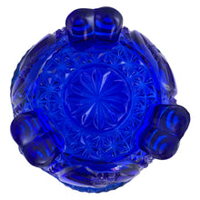 Load image into Gallery viewer, Large vintage cobalt blue love birds 3-footed, lidded candy dish, Byrdes reproduction. A licensed reproduction of the Hofbauer Byrdes model, 1990s. A gorgeous vessel to stash candy, keys, cotton balls and more!!!

In vintage condition with minor smooth chip to the outer rim and minor flea bites to both pieces which do not detract from the beauty of this piece thanks to the deep colour of the glass which tends to hide small issues.

Measures 7 1/2 x 7 1/2 inches
