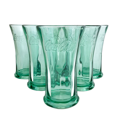 Vintage and collectible, these Coca-Cola aqua coloured flared glass tumblers feature the company logo, paneled lower half and a flared mouth. Crafted by LIbbey Glass company, circa 1990s.  In excellent condition, free from chips.  Measures 3 7/8 x 6 3/8 inches