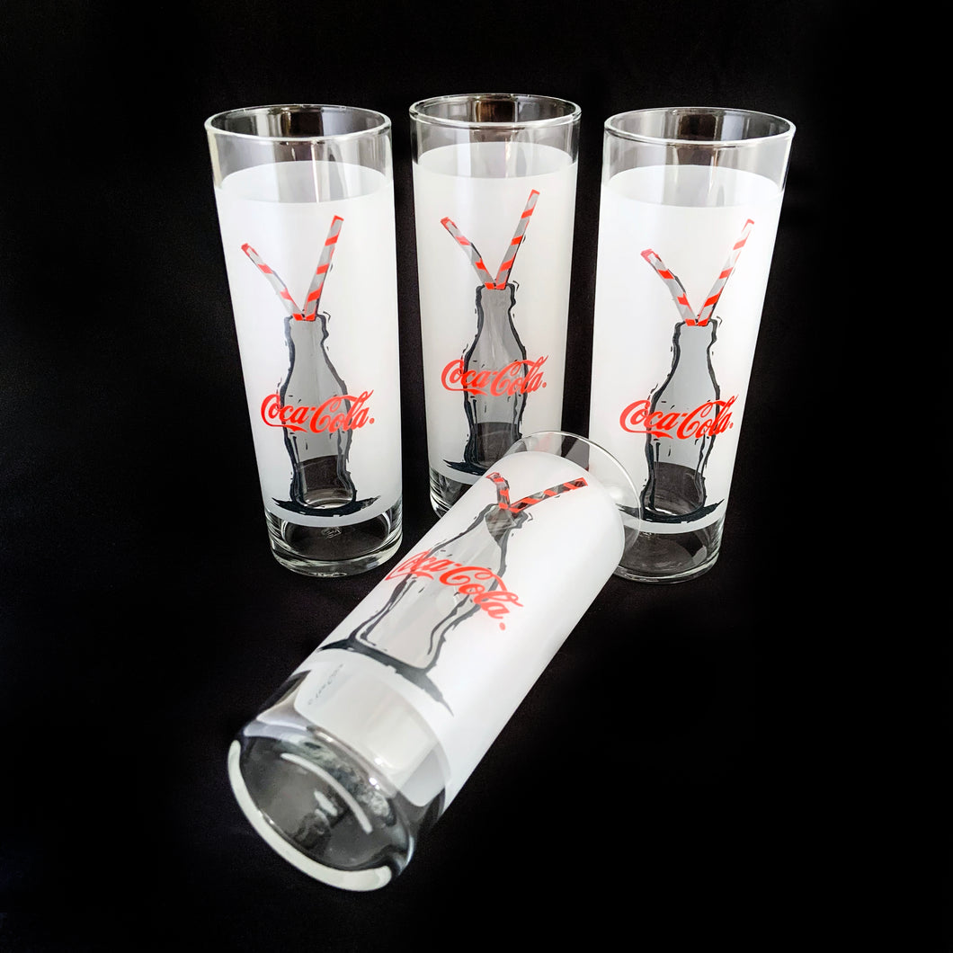 Vintage Coca-Cola Tom Collins cocktail glasses, featuring an illustrated Coke bottle with two red striped straws on a frosted band. Set of 4, Anchor Hocking, USA. Makes a great gift for the Coke collector in your life!  In excellent condition, free from chips/wear.  Measures 2 1/2 x 6 3/4 inches