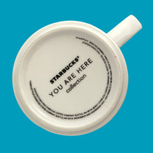 Load image into Gallery viewer, Underside of Starbucks Boston mug showing the You Are Here Collection mark, 2017 copyright and care information
