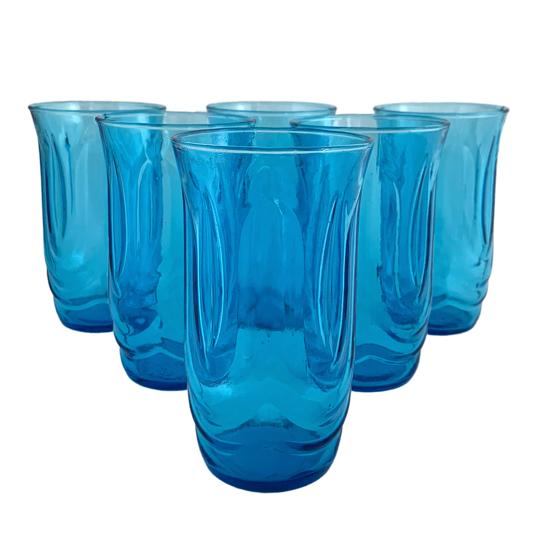 Set of six vintage Colonial Tulip pressed glass tumblers in striking laser blue. Crafted by Anchor Hocking, circa, 1970s. Fill with your favourite beverage and enjoy!  In excellent condition, free from chips.  Measures 2 7/8 x 5 1/8 inches   Capacity 12 ounces