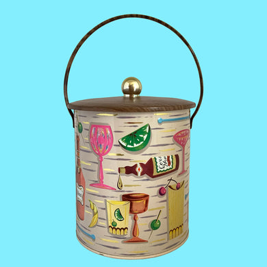 Funky vintage mid-century era metal ice bucket featuring colourful embossed cocktail graphics with faux woodgrain handle and lid with gold knob. These tins original held yummy biscuits and it comes with a removable white plastic liner. Such a fun piece of barware and a wonderful example of art in advertising!

In excellent vintage condition. Marked Baret Ware, Art Grace Container, Made in England and on the side Baret Ware 64/IB2

Measures 6 3/4 x 8 1/2 inches (11 5/8 with handle extended)