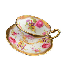 Load image into Gallery viewer, A gorgeous white bone china teacup and saucer featuring colourful pink roses, florals and a gold gilt trim. Crafted by EB Foley, England, 1948 – 1963.

In excellent vintage condition, no chips, cracks or repairs.

Teacup measures 3 3/4 x 2 1/4 inches

Saucer measures 5 5/8 inches
