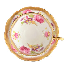 Load image into Gallery viewer, A gorgeous white bone china teacup and saucer featuring colourful pink roses, florals and a gold gilt trim. Crafted by EB Foley, England, 1948 – 1963.

In excellent vintage condition, no chips, cracks or repairs.

Teacup measures 3 3/4 x 2 1/4 inches

Saucer measures 5 5/8 inches

