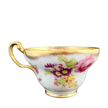 Load image into Gallery viewer, A gorgeous white bone china teacup and saucer featuring colourful pink roses, florals and a gold gilt trim. Crafted by EB Foley, England, 1948 – 1963.

In excellent vintage condition, no chips, cracks or repairs.

Teacup measures 3 3/4 x 2 1/4 inches

Saucer measures 5 5/8 inches
