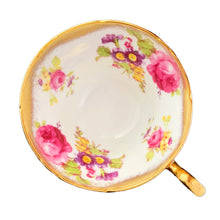 Load image into Gallery viewer, A gorgeous white bone china teacup and saucer featuring colourful pink roses, florals and a gold gilt trim. Crafted by EB Foley, England, 1948 – 1963.

In excellent vintage condition, no chips, cracks or repairs.

Teacup measures 3 3/4 x 2 1/4 inches

Saucer measures 5 5/8 inches
