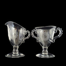 Load image into Gallery viewer, Vintage mid-century clear Candlewick footed cream pitcher and sugar cut with WJ Hughes Corn Flower pattern. Imperial Glass blank. Dates between 1937 - 1967. Candlewick is easily recognized by the series of small balls on the edges, handles and decorative details of the glass. An elegant addition to your tableware. Excellent condition, free from chips. Sugar measures 3 3/8 x 3 1/8 x 4 3/8 inches Creamer measures 3 1/4 x 2 7/8 x 5 inches
