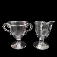 Load image into Gallery viewer, Vintage mid-century clear Candlewick footed cream pitcher and sugar cut with WJ Hughes Corn Flower pattern. Imperial Glass blank. Dates between 1937 - 1967. Candlewick is easily recognized by the series of small balls on the edges, handles and decorative details of the glass. An elegant addition to your tableware. Excellent condition, free from chips. Sugar measures 3 3/8 x 3 1/8 x 4 3/8 inches Creamer measures 3 1/4 x 2 7/8 x 5 inches
