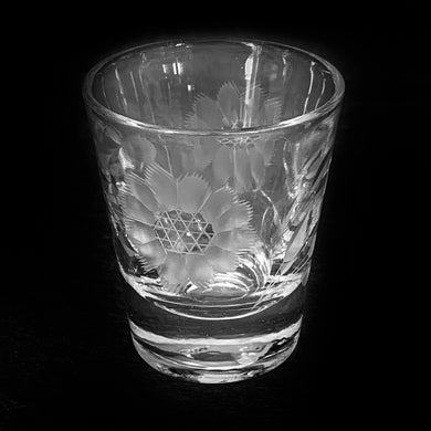 An elegant clear shot glass, cut with the 