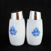 Load image into Gallery viewer, A classic set of vintage white milk glass salt and pepper shakers decorated with blue cornflowers with chrome lids with holes in the shape of an &quot;S&quot; and &quot;P&quot;. Produced by Van Pak in Canada, circa 1970  In excellent condition with only minor wear to the lids, the glass is free from chips/cracks.  Measures 1-3/4&quot; x 3-1/5&quot;
