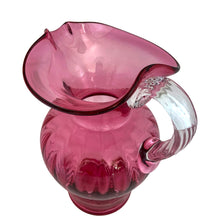 Load image into Gallery viewer, Beautiful vintage hand blown optic cranberry glass pitcher with wide wavy rim and applied glass handle. Crafted by Pilgrim Glass, USA. A stunning piece of handcrafted art glass, practical and beautiful!  In excellent condition, no chips. Measures 6 x 9 1/2 inches. Capacity 64 ounces
