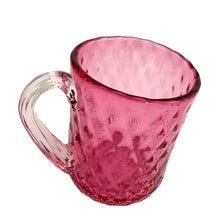 Load image into Gallery viewer, Stunning vintage hand blown cranberry optic glass mug, features a quilted diamond pattern with applied clear ribbed glass handle. Expertly crafted by Rossi Art Glass, Canada, circa 1980s. Perfect for way to elevate your hot beverage! In excellent condition, free from chips. Measures 3 1/2 x 4 3/4 inches
