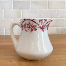 Load image into Gallery viewer, Vintage cranberry red floral transferware white ceramic handled creamer. Crafted by McNicol China, USA. The charming sidekick to your morning coffee or tea!

In excellent condition, no chips/cracks.

Measures 2 3/4 x 2 3/4 inches
