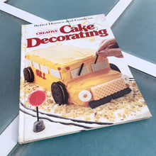 Load image into Gallery viewer, Better Homes and Gardens is known for its fabulous cookbooks. This hardcover cookbook focuses on creative cake decorating recipes and designs. Its 96 pages are filled with amazing recipes along with many colour photographs. Originally published by Meredith Corporation, USA, 1983. This is the third printing 1984.   In great vintage condition with normal age-related yellowing.
