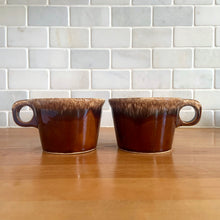 Load image into Gallery viewer, Pair of vintage Crestone glossy brown drip glaze mugs with flare rim. Crafted by Hull Pottery, USA, 1960s. Enjoy any hot beverage in this fabulous retro oven-proof tableware!

In excellent condition, no chips/cracks/repairs. Maker&#39;s marks.

Measures 4 x 2 3/4 inches

Capacity 8 ounces
