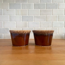 Load image into Gallery viewer, Pair of vintage Crestone glossy brown drip glaze mugs with flare rim. Crafted by Hull Pottery, USA, 1960s. Enjoy any hot beverage in this fabulous retro oven-proof tableware!

In excellent condition, no chips/cracks/repairs. Maker&#39;s marks.

Measures 4 x 2 3/4 inches

Capacity 8 ounces
