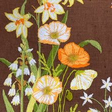 Load image into Gallery viewer, Vintage hand stitched crewel of a floral still life in shades of orange, yellow, pink and green on deep brown linen which makes the design pop! This piece is frame in gold-toned metal. There is a tag on the back that states, &quot;Hand Made By Jeanette Burgie&quot;, circa 1970s.  The crewel is in excellent condition. We recommend reframing this piece with a more sturdy backing.  Overall measures 16 1/8 x 20 1/4 inches
