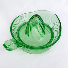 Load image into Gallery viewer, We are loving this vintage green uranium depression glass &quot;Criss Cross&quot; citrus juice reamer. This piece is extra special because it glows brilliantly under black light! Every home should have one of these practical kitchen helpers that makes squeezing every juicy ounce from your oranges, lemons and limes super easy! This one has a convenient spout and smooth finger handle design. Produced by Hazel-Atlas Glass, USA, circa 1930s. Perfect for the fresh squeezed juice enthusiast...no sugar added! 
