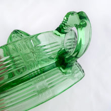 Load image into Gallery viewer, We are loving this vintage green uranium depression glass &quot;Crisscross&quot; citrus juice reamer. This piece is extra special because it glows brilliantly under black light! Every home should have one of these practical kitchen helpers that makes squeezing every juicy ounce from your oranges, lemons and limes super easy! This one has a convenient spout and smooth finger handle design. Produced by Hazel-Atlas Glass, USA, circa 1930s. Perfect for the fresh squeezed juice enthusiast...no sugar added! 
