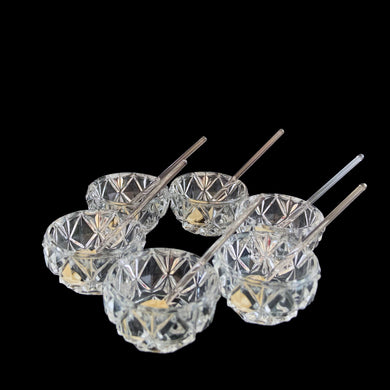 Vintage set of six crystal salt cellars and spoons. Crafted by Bohemia Crystal, circa 1950s. A lovely addition to your tablescape. New in box in excellent vintage condition. Each spoon is wrapped and has the original yellow sticker which reads Bohemia Crystal, Made in Czechoslovakia. Salt cellars measure 1 5/8 x 7/8 inches. Spoons measure 2 3/4 inches