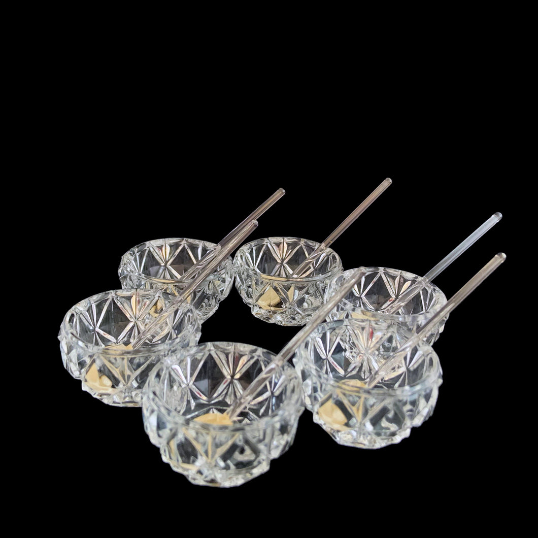 Vintage set of six crystal salt cellars and spoons. Crafted by Bohemia Crystal, circa 1950s. A lovely addition to your tablescape. New in box in excellent vintage condition. Each spoon is wrapped and has the original yellow sticker which reads Bohemia Crystal, Made in Czechoslovakia. Salt cellars measure 1 5/8 x 7/8 inches. Spoons measure 2 3/4 inches