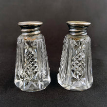 Load image into Gallery viewer, Enhance your tablescape with these sparkling vintage fine cut crystal tower-shaped salt and peppers shakers topped with silver lids inlaid with mother-of-pearl....stunning!  The crystal is in excellent condition. The sterling silver lids are worn, but could shine up nicely if polished.  Measures 1 1/8 x 2 inches   
