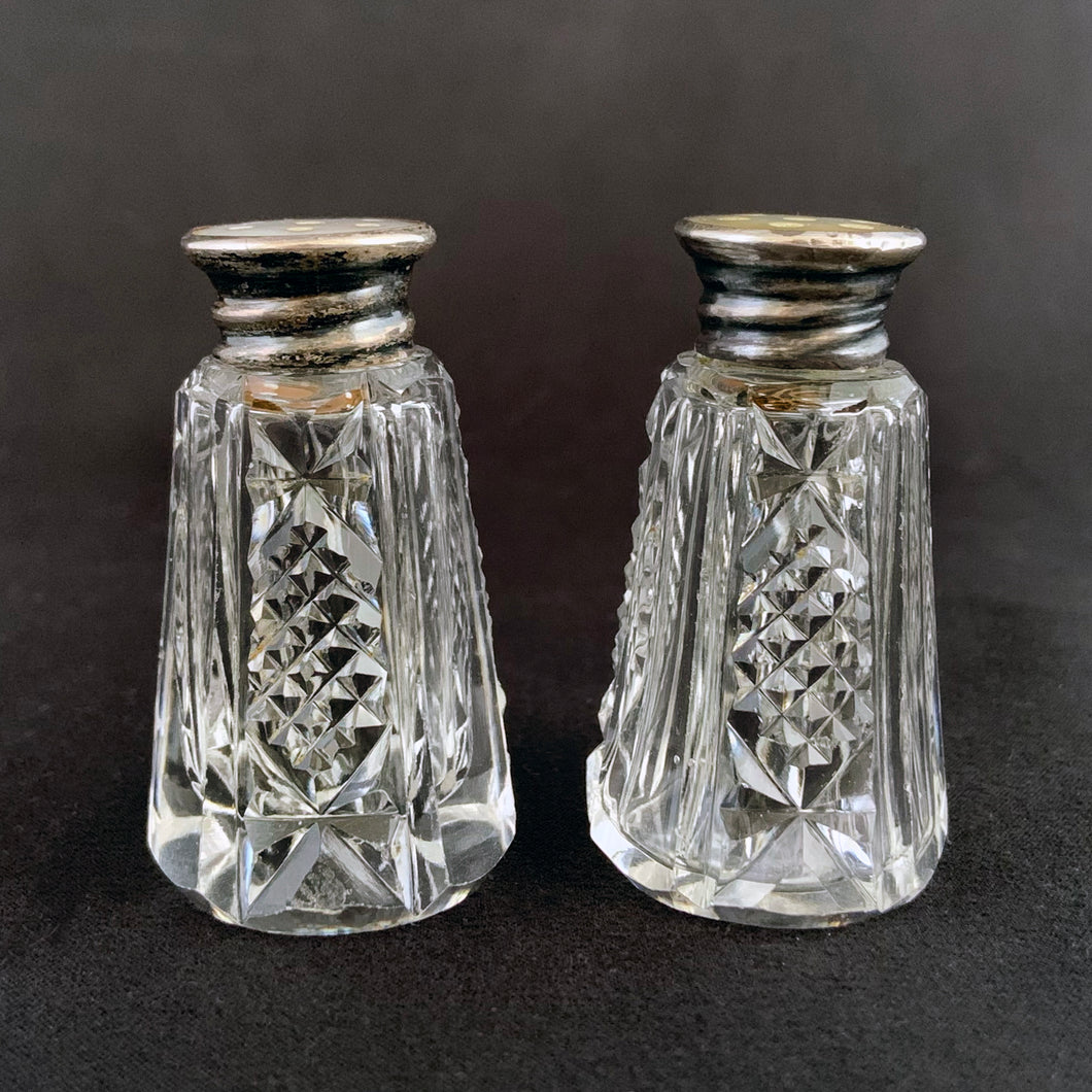 Enhance your tablescape with these sparkling vintage fine cut crystal tower-shaped salt and peppers shakers topped with silver lids inlaid with mother-of-pearl....stunning!  The crystal is in excellent condition. The sterling silver lids are worn, but could shine up nicely if polished.  Measures 1 1/8 x 2 inches   