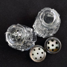 Load image into Gallery viewer, Enhance your tablescape with these sparkling vintage fine cut crystal tower-shaped salt and peppers shakers topped with silver lids inlaid with mother-of-pearl....stunning!  The crystal is in excellent condition. The sterling silver lids are worn, but could shine up nicely if polished.  Measures 1 1/8 x 2 inches   
