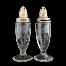 Load image into Gallery viewer, Beautiful pair of antique clear pressed glass salt and pepper shakers featuring a cut pattern of florals and vertical bands topped with silver plated lids. Possibly Fry Glass, Roden Silver for Birks Canada, early 20th century.  In excellent vintage condition, no chips to the glass. Lids are marked, see photo.  Measures 1 5/8 x 4 1/2 inches
