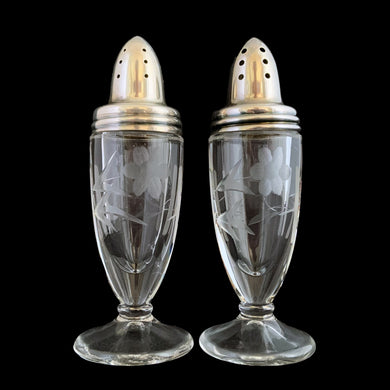 Beautiful pair of antique clear pressed glass salt and pepper shakers featuring a cut pattern of florals and vertical bands topped with silver plated lids. Possibly Fry Glass, Roden Silver for Birks Canada, early 20th century.  In excellent vintage condition, no chips to the glass. Lids are marked, see photo.  Measures 1 5/8 x 4 1/2 inches
