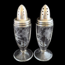 Load image into Gallery viewer, Beautiful pair of antique clear pressed glass salt and pepper shakers featuring a cut pattern of florals and vertical bands topped with silver plated lids. Possibly Fry Glass, Roden Silver for Birks Canada, early 20th century.  In excellent vintage condition, no chips to the glass. Lids are marked, see photo.  Measures 1 5/8 x 4 1/2 inches
