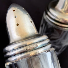 Load image into Gallery viewer, Beautiful pair of antique clear pressed glass salt and pepper shakers featuring a cut pattern of florals and vertical bands topped with silver plated lids. Possibly Fry Glass, Roden Silver for Birks Canada, early 20th century.  In excellent vintage condition, no chips to the glass. Lids are marked, see photo.  Measures 1 5/8 x 4 1/2 inches
