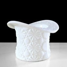 Load image into Gallery viewer, This vintage milk glass top hat captures mid-century charm with its signature Daisy and Button embossed design. Crafted by Indiana Glass, USA, 1960s. Serve candies and nuts in style, or reimagine it as a holder for brushes, a bud vase, or desktop organizer—its versatility makes it an indispensable addition to any curated space. A timeless piece that proves vintage treasures deserve a place in today's home.

In excellent condition, no chips.

Measures 4 1/2 x 3 1/4 inches

