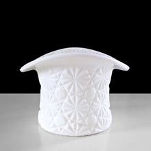 Load image into Gallery viewer, This vintage milk glass top hat captures mid-century charm with its signature Daisy and Button embossed design. Crafted by Indiana Glass, USA, 1960s. Serve candies and nuts in style, or reimagine it as a holder for brushes, a bud vase, or desktop organizer—its versatility makes it an indispensable addition to any curated space. A timeless piece that proves vintage treasures deserve a place in today's home.

In excellent condition, no chips.

Measures 4 1/2 x 3 1/4 inches
