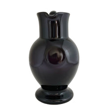Load image into Gallery viewer, Vintage deep purple hand blown glass pitcher with applied curled handle and smooth pontil. Maker unknown. A stunning and versatile pitcher that may be used to serve your favourite beverage, serve as a flower vase or artisanal glass decor.

In excellent used condition, no chips, minor wear.

Measures 7 x 5 x 10 (incl handle/spout)
