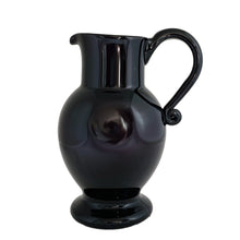 Load image into Gallery viewer, Vintage deep purple hand blown glass pitcher with applied curled handle and smooth pontil. Maker unknown. A stunning and versatile pitcher that may be used to serve your favourite beverage, serve as a flower vase or artisanal glass decor.

In excellent used condition, no chips, minor wear.

Measures 7 x 5 x 10 (incl handle/spout)
