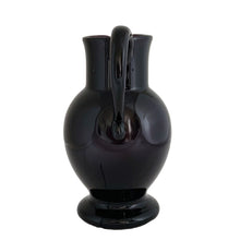 Load image into Gallery viewer, Vintage deep purple hand blown glass pitcher with applied curled handle and smooth pontil. Maker unknown. A stunning and versatile pitcher that may be used to serve your favourite beverage, serve as a flower vase or artisanal glass decor.

In excellent used condition, no chips, minor wear.

Measures 7 x 5 x 10 (incl handle/spout)
