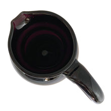 Load image into Gallery viewer, Vintage deep purple hand blown glass pitcher with applied curled handle and smooth pontil. Maker unknown. A stunning and versatile pitcher that may be used to serve your favourite beverage, serve as a flower vase or artisanal glass decor.

In excellent used condition, no chips, minor wear.

Measures 7 x 5 x 10 (incl handle/spout)
