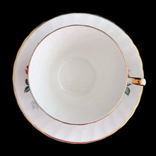 Load image into Gallery viewer, Vintage fine bone china teacup and saucer featuring dark pink roses, pale blue baby&#39;s breath and gold gilt trim on a swirl shape. Crafted by Delphine, England, 1930 - 1941. A lovely way to enjoy a cuppa tea!

In excellent condition, no chips, cracks or repairs. Maker&#39;s mark on the bottom.

Measures 3 3/8 x 2 1/2 inches | Saucer measures 5 3/4 inches
