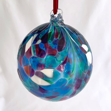 Enjoy the unique beauty of this vintage hand blown glass ball suncatcher with its exotic mix of blues, purples, greens, magentas and white! Hang it up in your window and see the sun transform it into a dazzling display of mesmerizing colours!  In excellent condition.  Measures 4 1/8 inches