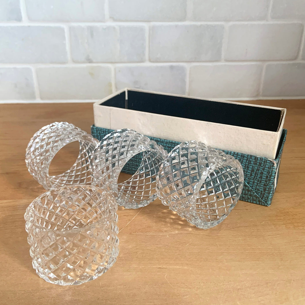 Set of four vintage diamond pattern round glass napkin rings. Crafted in Czechoslovakia, 1960s. Add sparkle to your tablescape with these classic napkin rings.

In excellent condition, no chips. In original box.

Measures 2 x 1 1/4 inches