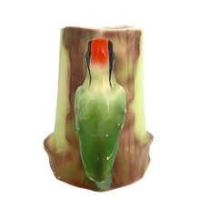 Load image into Gallery viewer, Handle view of vintage Czech Majolica woodpecker pitcher showing bird perched on tree stump body, red crown and green plumage detail visible from behind
