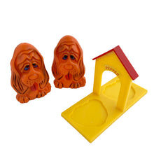 Load image into Gallery viewer, Vintage plastic rusty-orange Basset hound dog salt and pepper shaker with yellow and red dog house tray, plastic stoppers. JSNY, Hong Hong 1970s. Add these adorable shakers to your collection!

In excellent vintage condition. Maker&#39;s mark on dogs and tray bottom .

Dog measures 1 3/4 x 1 1/2 x 3 inches, tray measures 4 5/8 x 2 x 3 3/8 inches
