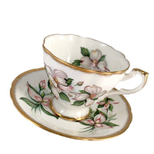Load image into Gallery viewer, Vintage Dogwood fine bone china teacup and saucer featuring hand painted flowers in shades of pink, gray and green with brush gold gilt trim. Crafted by Paragon, England, 1960s. A lovely way to enjoy a cuppa tea!

In excellent condition, no chips, cracks or repairs. Maker&#39;s mark on the bottom.

Measures 3 3/4 x 2 3/4 inches | Saucer measures 5 inches
