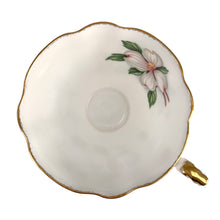 Load image into Gallery viewer, Vintage Dogwood fine bone china teacup and saucer featuring hand painted flowers in shades of pink, gray and green with brush gold gilt trim. Crafted by Paragon, England, 1960s. A lovely way to enjoy a cuppa tea!

In excellent condition, no chips, cracks or repairs. Maker&#39;s mark on the bottom.

Measures 3 3/4 x 2 3/4 inches | Saucer measures 5 inches
