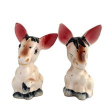 Load image into Gallery viewer, Vintage donkey ceramic salt and pepper shakers with stoppers. Japan, 1960s. Add these adorable kitschy shakers&nbsp;to your collection!

In excellent condition, no chips/cracks/repairs.

Measures 2 5/8 x 2 1/4 x 4 1/8 inches
